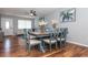 Dining area with a wood table and blue chairs, hardwood floors and ceiling fan at 140 Columbia Rd, Venice, FL 34293