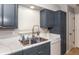 Kitchen with updated cabinets, marble countertops, and a double sink at 140 Columbia Rd, Venice, FL 34293