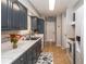 Bright kitchen features updated cabinetry, marble countertops, and stainless steel appliances at 140 Columbia Rd, Venice, FL 34293