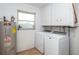 Laundry room with washer, dryer, and ample cabinet space at 140 Columbia Rd, Venice, FL 34293
