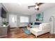 Living room with sectional sofa, large TV, and hardwood flooring at 140 Columbia Rd, Venice, FL 34293