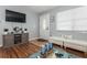 Living room features hardwood floors, comfy seating, and a large TV at 140 Columbia Rd, Venice, FL 34293