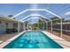 Inviting screened-in pool with floating toys and patio furniture at 140 Columbia Rd, Venice, FL 34293