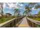 Beach boardwalk with scenic views and covered seating areas at 1423 Avenida Del Circo # 1C, Venice, FL 34285