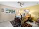 Cozy bedroom with wood framed bed and geometric patterned rug at 1423 Avenida Del Circo # 1C, Venice, FL 34285