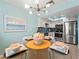 Modern kitchen with stainless steel appliances and light-blue cabinetry at 1423 Avenida Del Circo # 1C, Venice, FL 34285