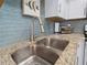 Stainless steel double sink with granite countertop at 1423 Avenida Del Circo # 1C, Venice, FL 34285