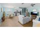 Bright living room with open floor plan, featuring a kitchen and dining area at 1423 Avenida Del Circo # 1C, Venice, FL 34285