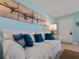Living room with white couch and airplane artwork at 1423 Avenida Del Circo # 1C, Venice, FL 34285