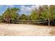 Outdoor volleyball court with sand and surrounding trees at 1423 Avenida Del Circo # 1C, Venice, FL 34285