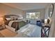 Bright bedroom with king bed, large window, and sitting area at 1437 57Th W St # 1437, Bradenton, FL 34209