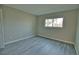 Well-lit bedroom with gray wood-look flooring at 1437 57Th W St # 1437, Bradenton, FL 34209