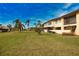 Building exterior with lush green lawn and palm trees at 1437 57Th W St # 1437, Bradenton, FL 34209