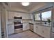 Updated kitchen with white cabinets, granite countertops, and stainless steel appliances at 1437 57Th W St # 1437, Bradenton, FL 34209
