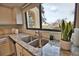 Modern kitchen sink with granite countertop and a view of the community at 1437 57Th W St # 1437, Bradenton, FL 34209
