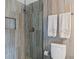 Bathroom with walk-in shower and grey tile at 1531 Placida Rd # 1-103, Englewood, FL 34223