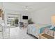 Bedroom with tiled floors, balcony access, and modern decor at 1531 Placida Rd # 1-103, Englewood, FL 34223