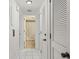 Clean hallway with tile floors, linen closet and bathroom access at 1531 Placida Rd # 1-103, Englewood, FL 34223