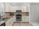 Modern kitchen with granite countertops and wood floors at 1531 Placida Rd # 1-103, Englewood, FL 34223