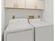 Bright laundry room with washer and dryer, and overhead cabinets at 1531 Placida Rd # 1-103, Englewood, FL 34223