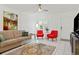 Living room with two red accent chairs and a sofa at 1531 Placida Rd # 1-103, Englewood, FL 34223