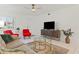 Living room featuring a large TV and comfy seating at 1531 Placida Rd # 1-103, Englewood, FL 34223
