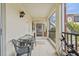 Cozy screened porch with table and chairs at 1531 Placida Rd # 1-103, Englewood, FL 34223