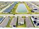 Community aerial view featuring a pond, tree lined streets and manicured lawns at 1920 Sunset Preserve Way, Port Charlotte, FL 33953