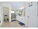 Bright bathroom featuring double sinks, a glass enclosed shower and tile flooring at 1920 Sunset Preserve Way, Port Charlotte, FL 33953