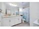 Well-lit bathroom with double vanity sinks, and a shower-tub combo at 1920 Sunset Preserve Way, Port Charlotte, FL 33953