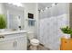 Clean bathroom with a vanity sink, toilet and shower with nature themed curtain at 1920 Sunset Preserve Way, Port Charlotte, FL 33953