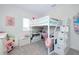 Bright bedroom featuring a loft bed with shelves and a desk at 1920 Sunset Preserve Way, Port Charlotte, FL 33953