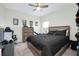 Bedroom with a ceiling fan, dresser and a bed with black bedding at 1920 Sunset Preserve Way, Port Charlotte, FL 33953