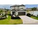 Beautiful two-story home featuring manicured landscaping, brick driveway, and a two-car garage at 1920 Sunset Preserve Way, Port Charlotte, FL 33953