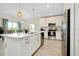 Modern kitchen with stainless steel appliances, white cabinets, and center island at 1920 Sunset Preserve Way, Port Charlotte, FL 33953
