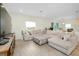 Comfortable living room featuring a large sectional sofa, and views into the dining area at 1920 Sunset Preserve Way, Port Charlotte, FL 33953