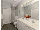 Bathroom with double vanity, shower, and gray tile flooring at 1931 San Silvestro Dr, Venice, FL 34285