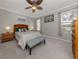 Spacious bedroom with wood furniture, ceiling fan, and large windows at 1931 San Silvestro Dr, Venice, FL 34285