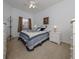 Cozy bedroom with carpeted floor, a queen bed, and plenty of natural light at 1931 San Silvestro Dr, Venice, FL 34285