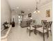 Bright dining area with glass-top table and chairs, adjacent to living room at 1931 San Silvestro Dr, Venice, FL 34285