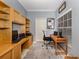 Home office with built-in shelving, two workspaces, and a view of backyard at 1931 San Silvestro Dr, Venice, FL 34285