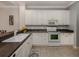 Modern kitchen with white cabinets, granite countertops, and stainless steel appliances at 1931 San Silvestro Dr, Venice, FL 34285