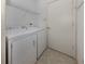 Laundry room with washer, dryer, and overhead shelving at 1931 San Silvestro Dr, Venice, FL 34285