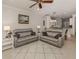 Open living room with gray sofas and view into the kitchen area at 1931 San Silvestro Dr, Venice, FL 34285