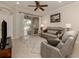 Spacious living room with gray reclining sofas and a view of the patio at 1931 San Silvestro Dr, Venice, FL 34285