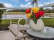 Comfortable patio seating with a view of a peaceful lake at 1931 San Silvestro Dr, Venice, FL 34285