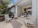 View of a relaxing screened patio with wicker furniture at 1931 San Silvestro Dr, Venice, FL 34285