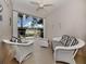Relaxing sunroom with wicker furniture and view of a lake at 1931 San Silvestro Dr, Venice, FL 34285