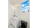 Small bathroom with white vanity and black toilet at 213 The Esplanade S, Venice, FL 34285