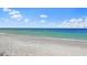 Expansive view of a tranquil beach with clear water at 213 The Esplanade S, Venice, FL 34285